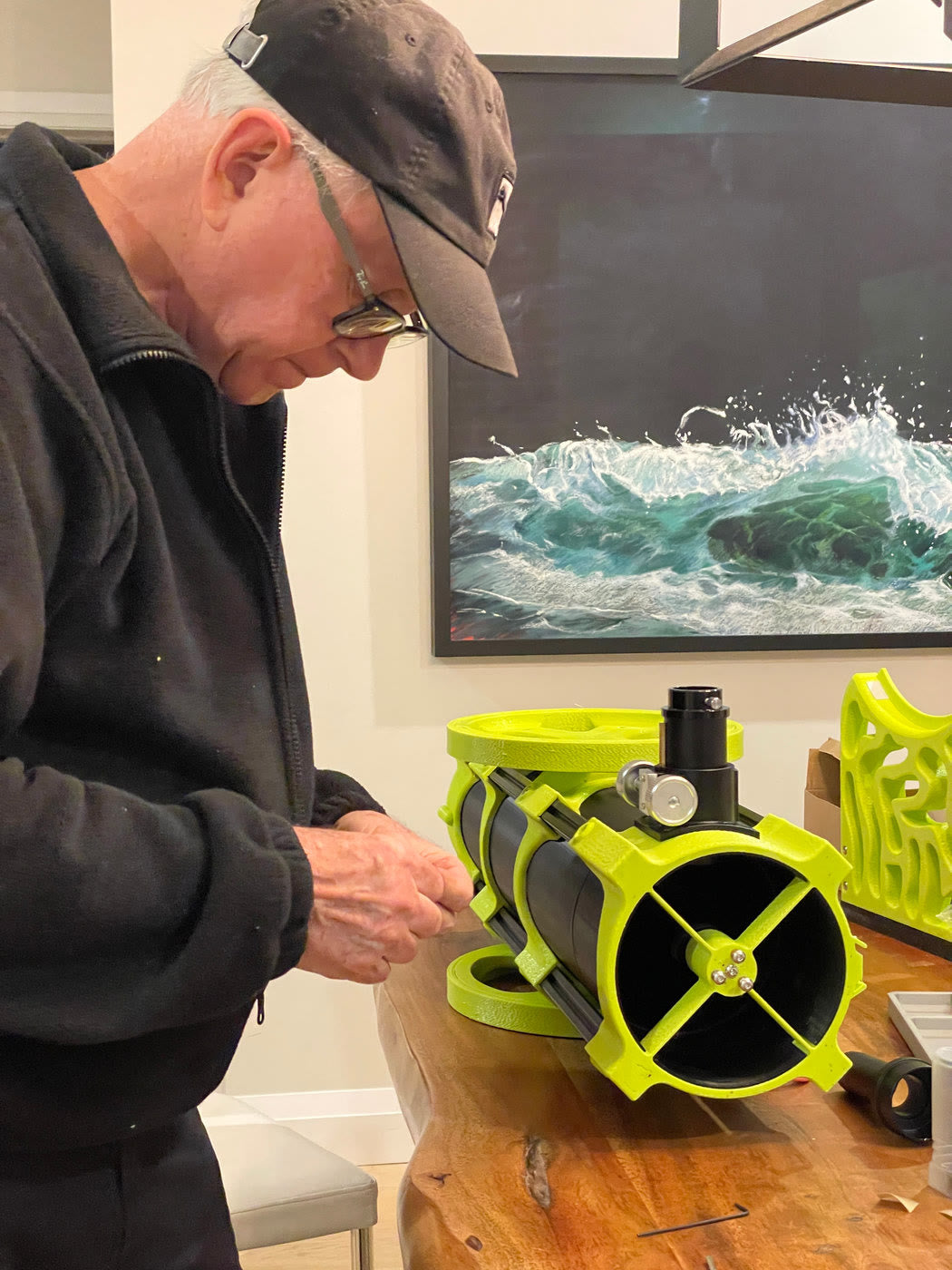 Volunteer assembling a yellow-green optical tube