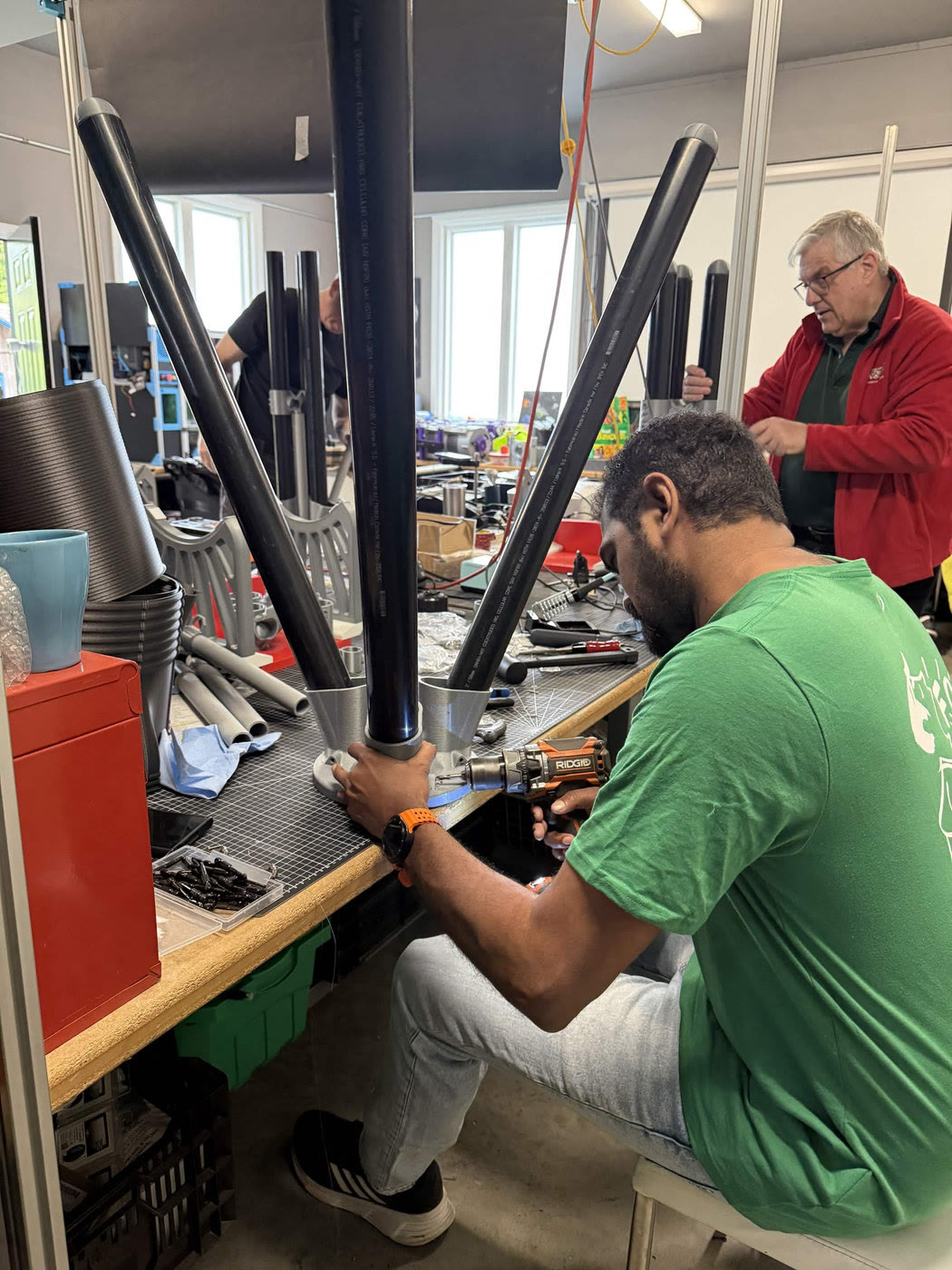 Volunteer fitting truss tubes into a Skyward 200