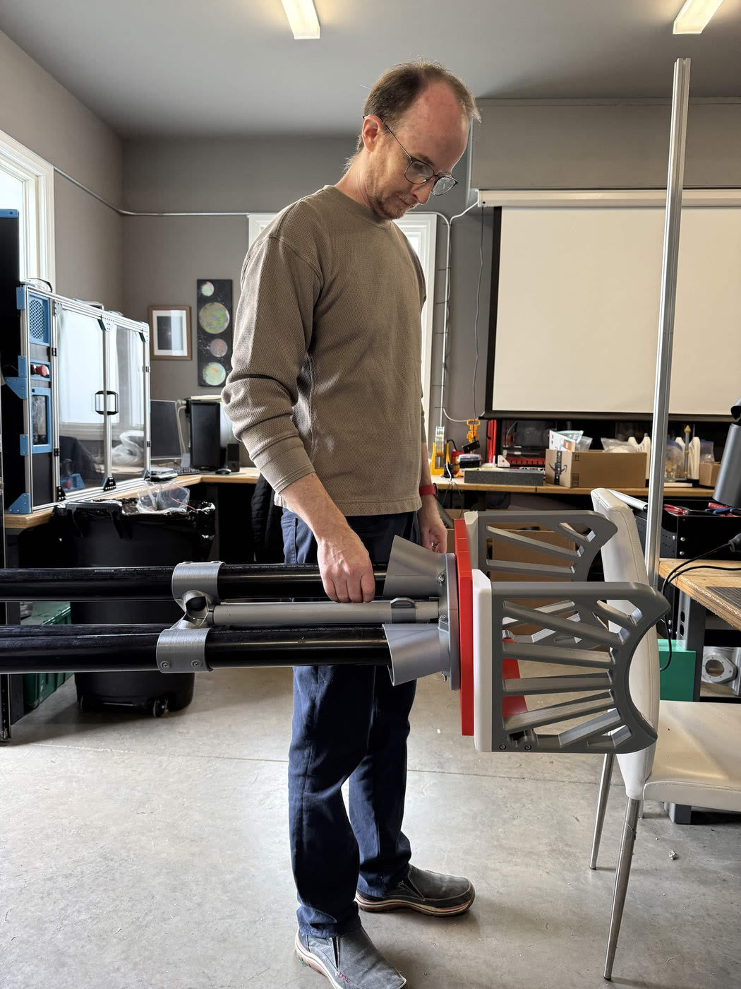 Volunteer carrying a finished optical tube assembly